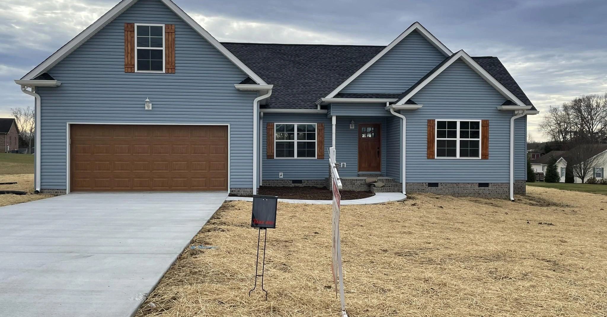 Completed home exterior with blue siding