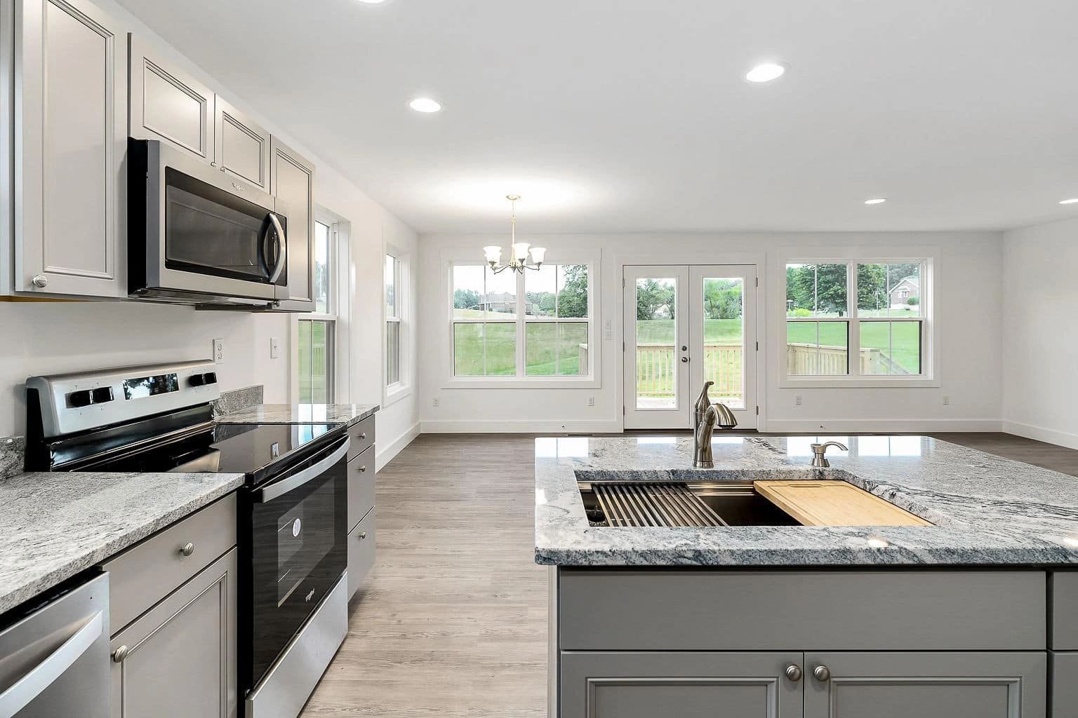 Modern kitchen with white cabinets and granite island